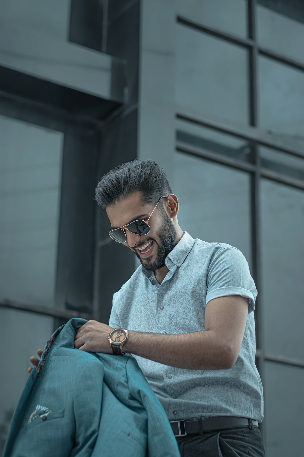 man in blue crew neck t-shirt wearing black sunglasses