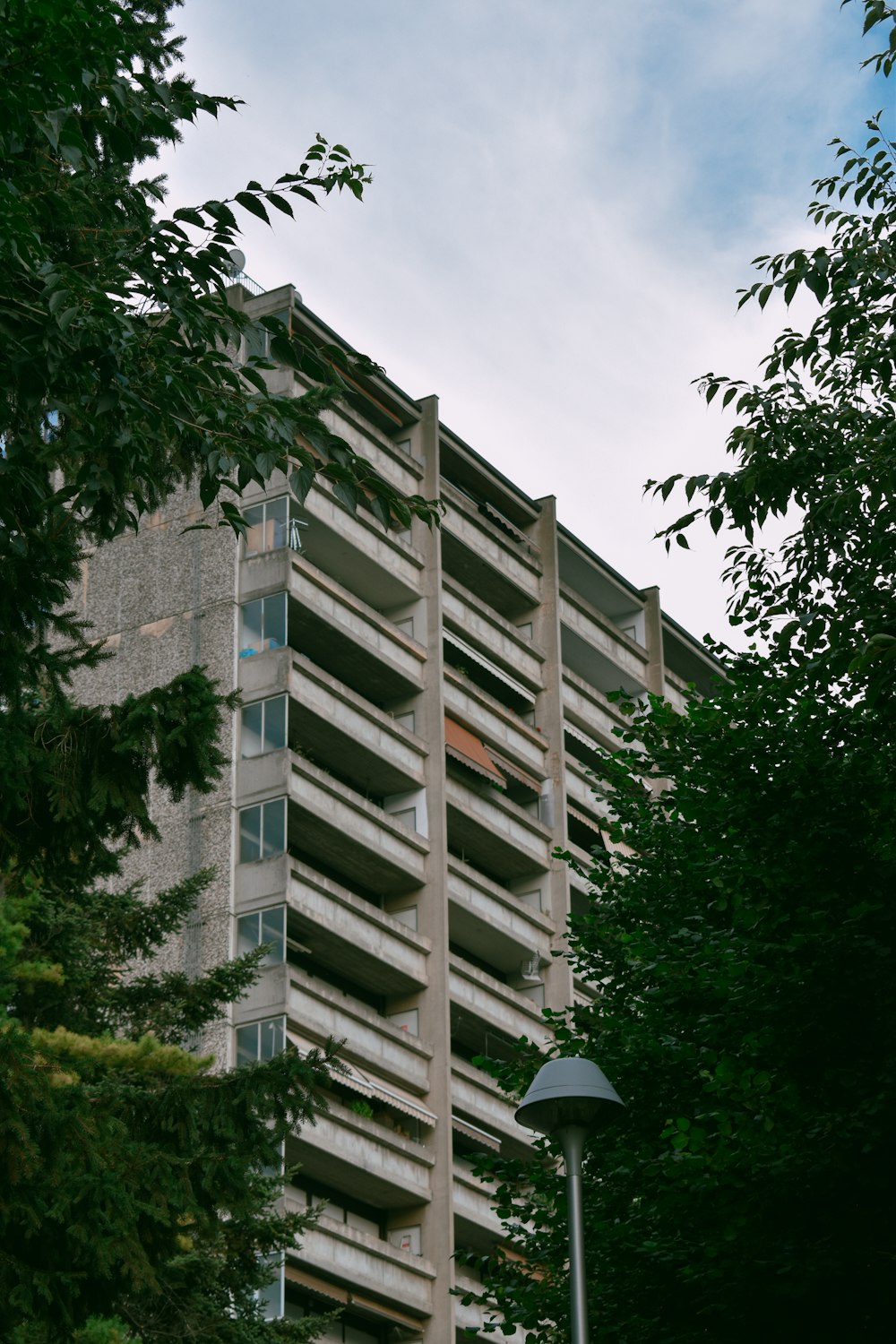 white concrete building near green trees during daytime