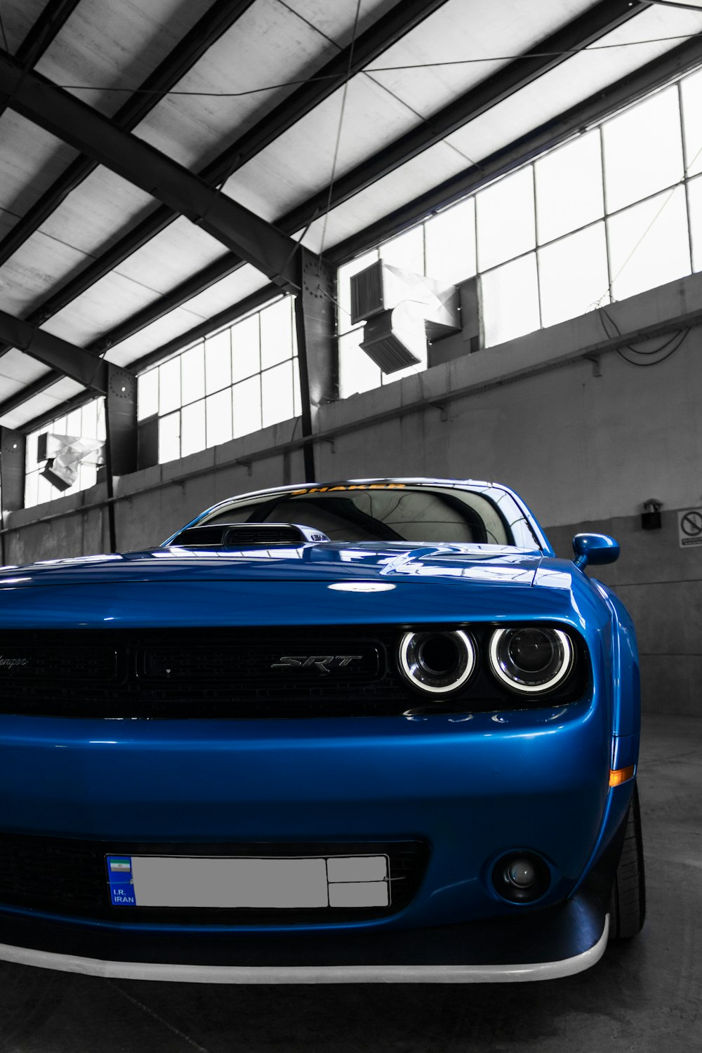 blue chevrolet camaro in a building