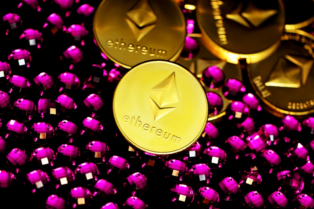 a pile of shiny gold and purple tokens