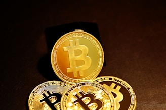 three gold bitcoins sitting on top of each other