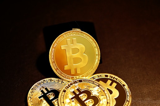 three gold bitcoins sitting on top of each other