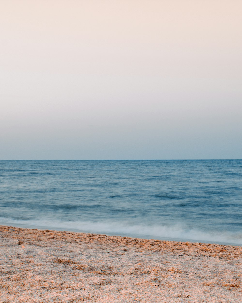 sea waves crashing on shore during daytime