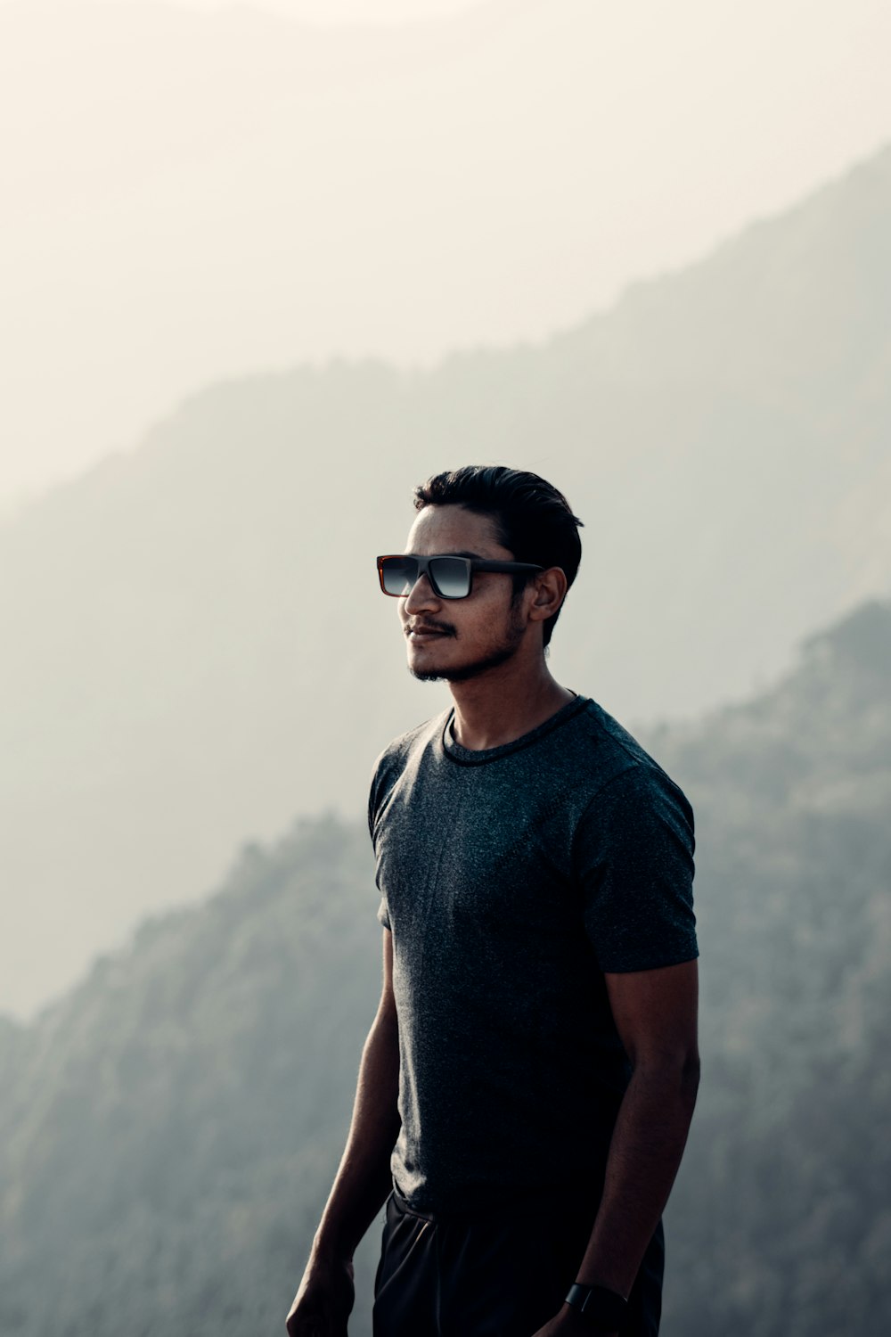 man in blue crew neck t-shirt wearing black sunglasses