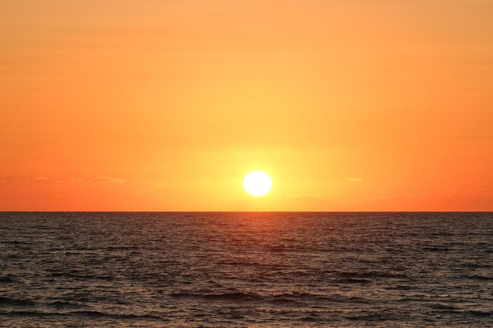 body of water during sunset