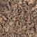 Dry, crumpled tea leaves form a densely packed texture. The leaves are dark and appear aged, with a mix of curled and twisted shapes.