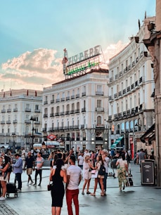 people walking on street near white concrete building during daytime
