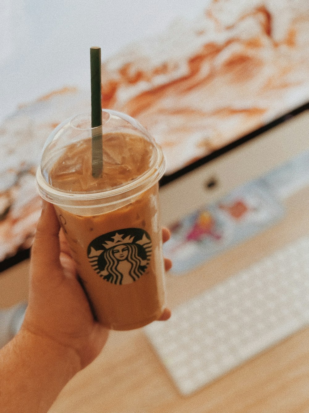 person holding white and brown disposable cup