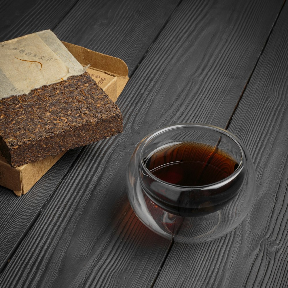 clear glass cup with brown liquid inside