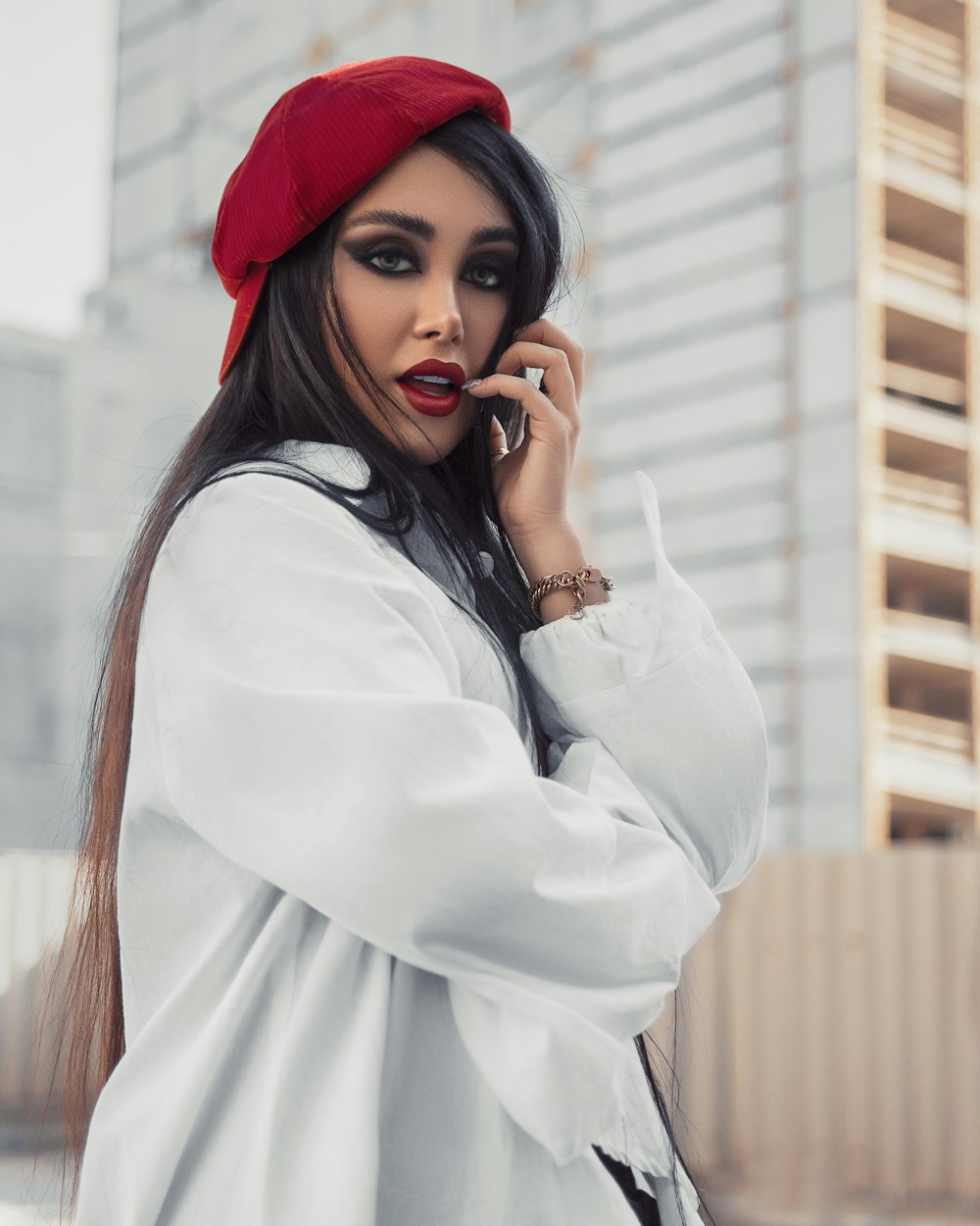 woman in white long sleeve shirt wearing red hat