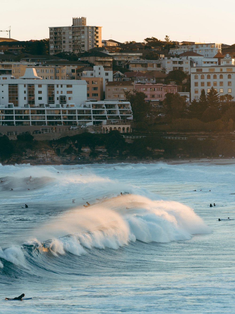 white sea waves near brown concrete building during daytime