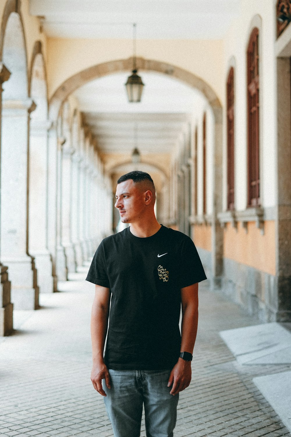 man in black crew neck t-shirt standing on hallway