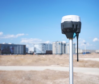 gray and black camera on gray metal stand during daytime