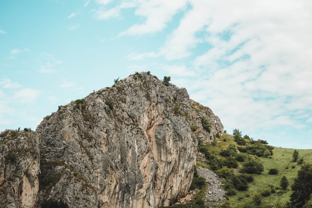 person standing on rock formation during daytime