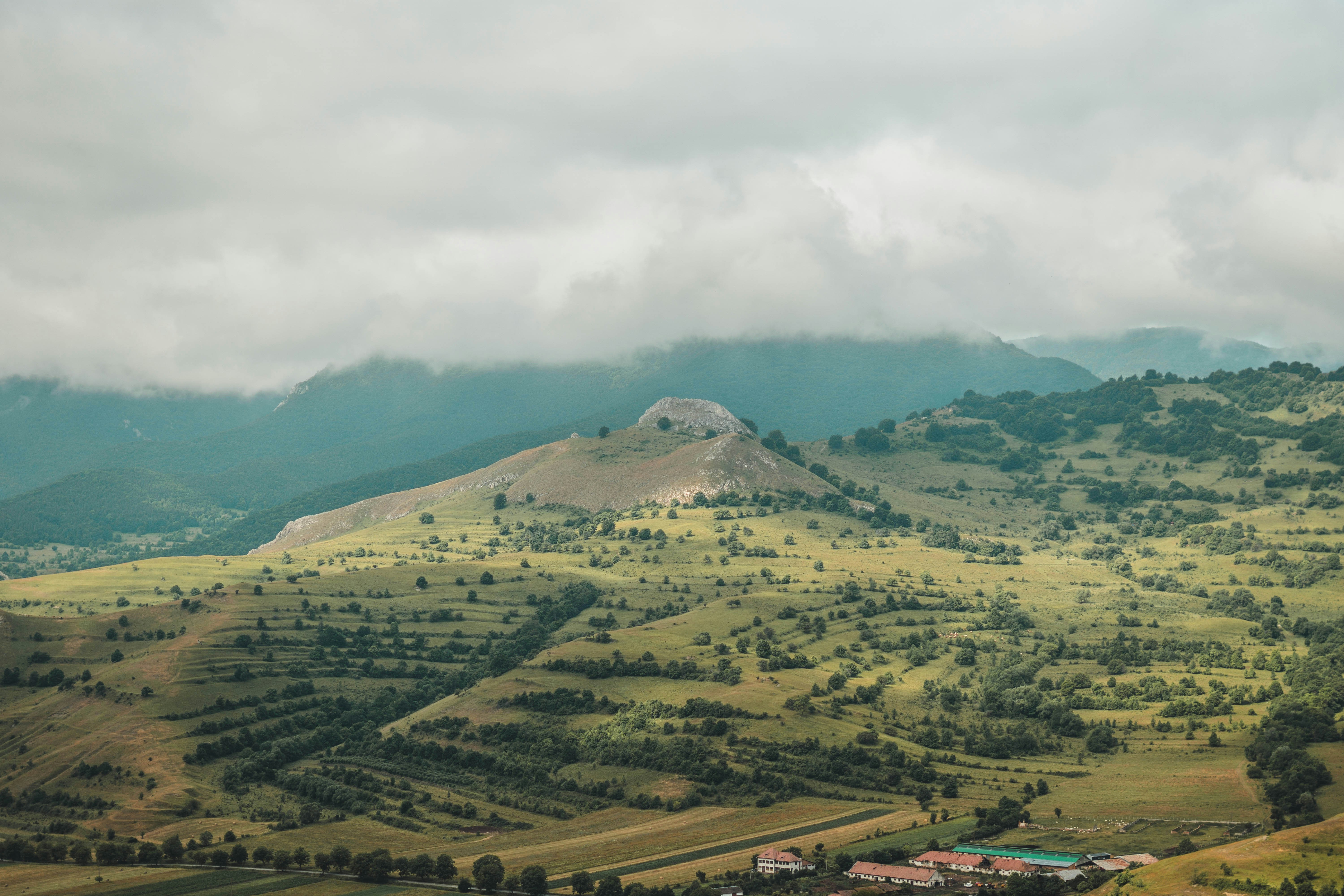 green and brown mountains under white clouds during daytime