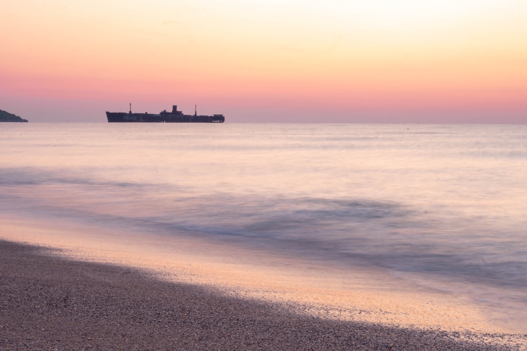 black ship on sea during daytime