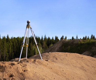 gray tripod on brown rock