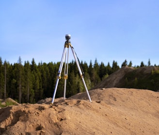 gray tripod on brown rock