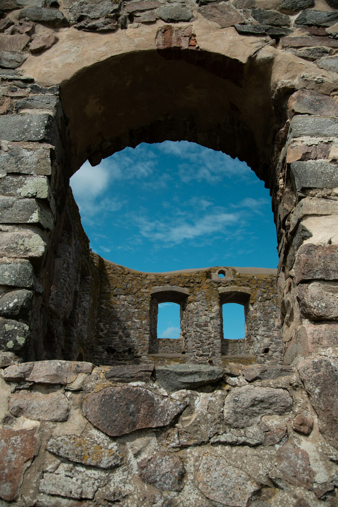 brown brick arch under blue sky during daytime