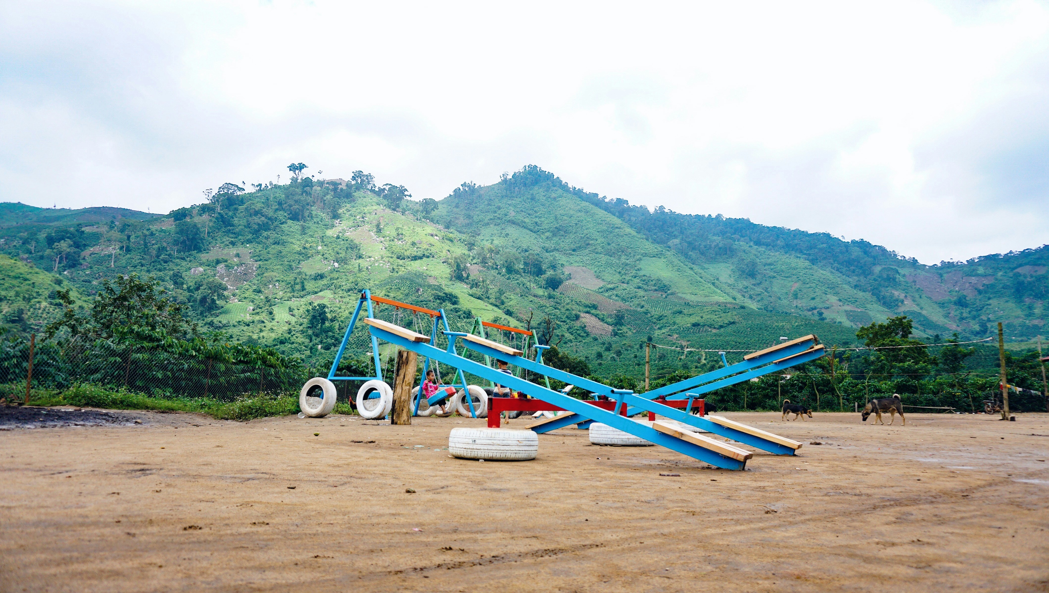 blue and black heavy equipment on brown dirt road during daytime