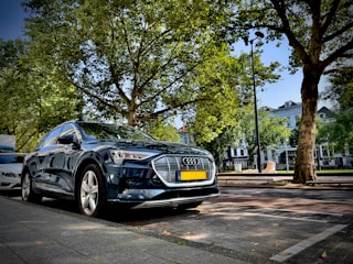 A sleek modern car parked on a sunny Marrakech street.