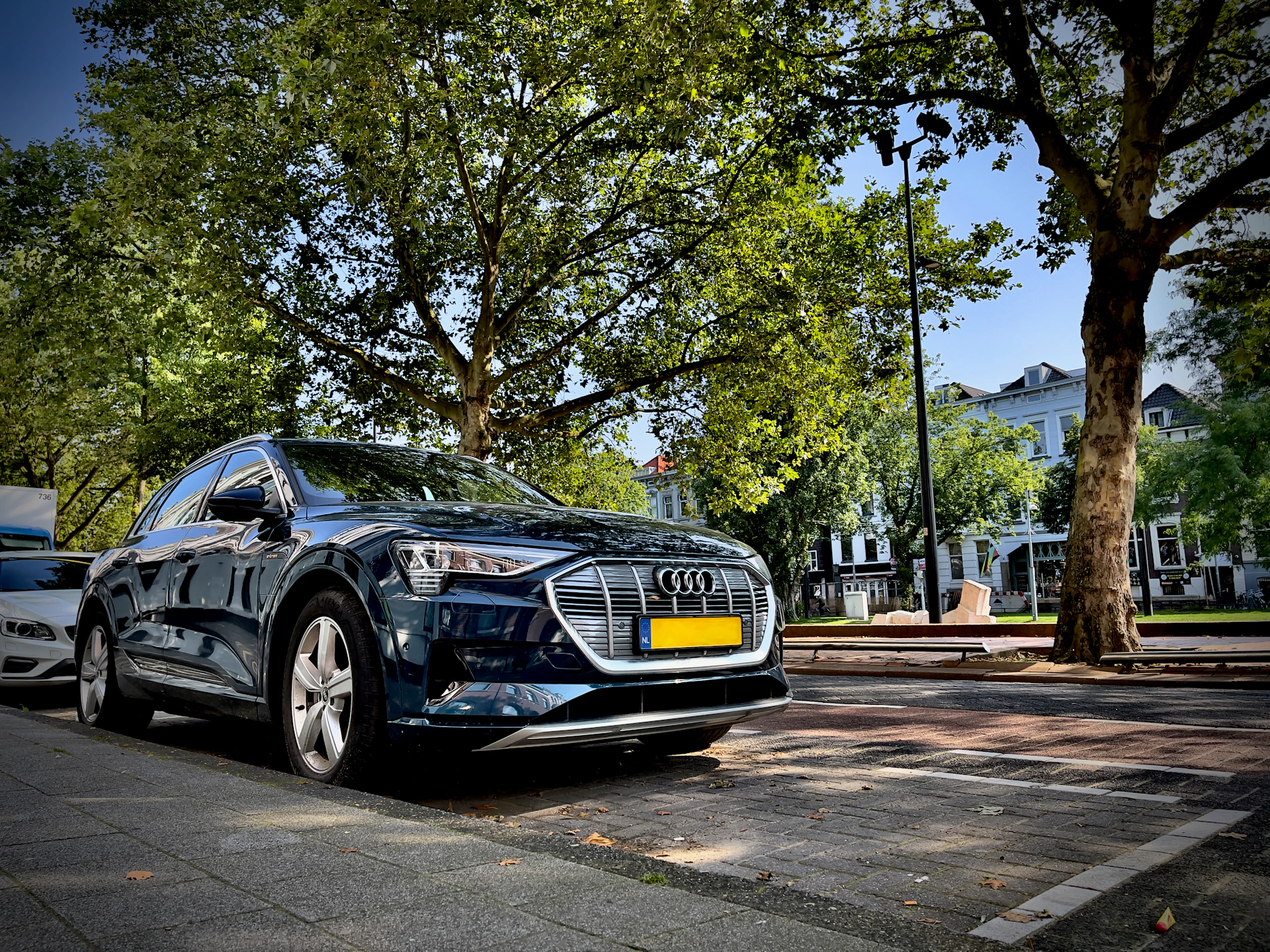 A stylish European luxury sedan parked in a modern cityscape, reflecting elegance and precision engineering.