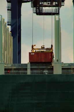 red and black ship on body of water during daytime