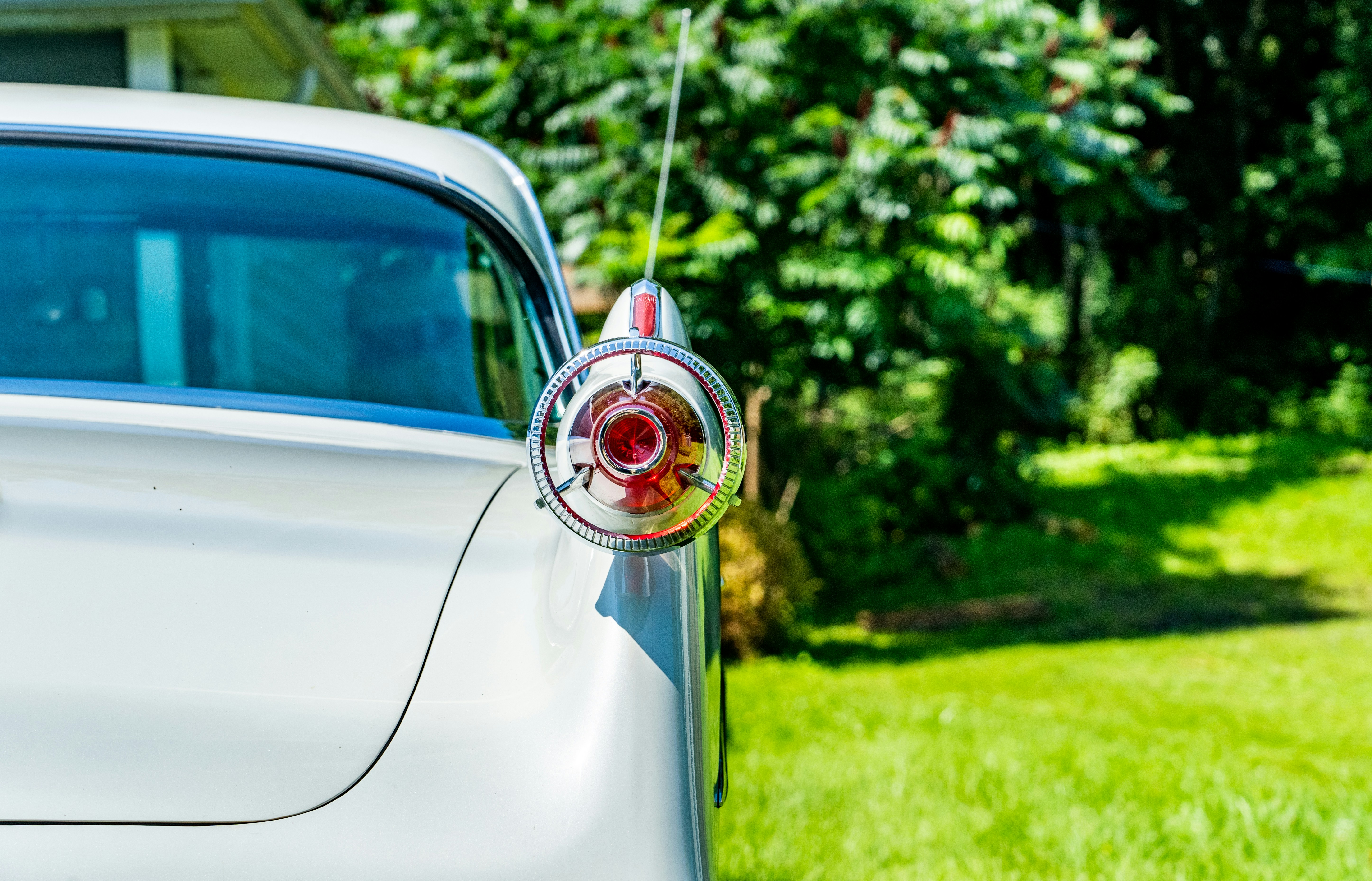 a white car parked in front of a house