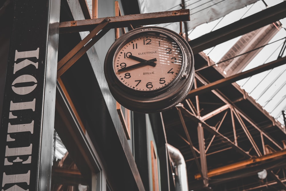 black and white analog wall clock at 10 00