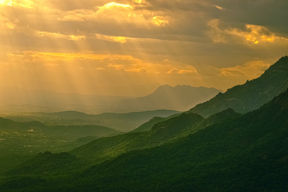 green mountains under white clouds during daytime