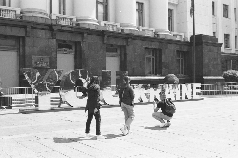 grayscale photo of people walking on street