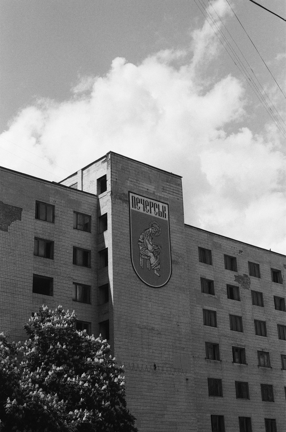 a black and white photo of a building with a sign on it