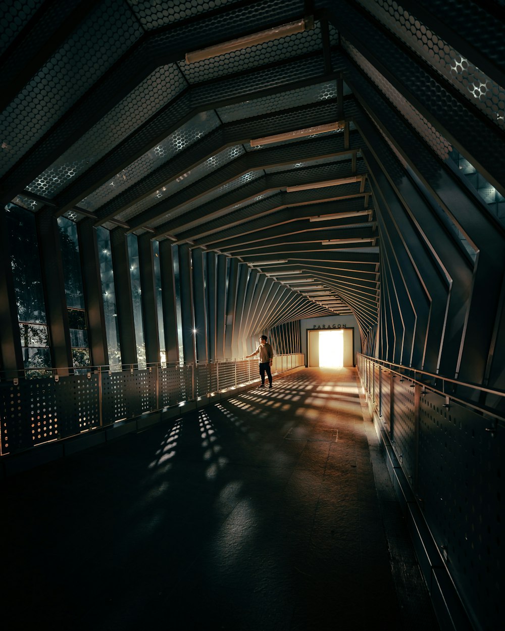 person walking on hallway with light turned on during daytime