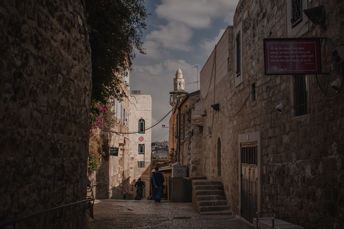 West Jerusalem — pedestrians walking through an Old City alley in the modern Israeli city