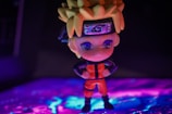 Gaming-inspired collectible figure standing on a charcoal base with neon highlights.