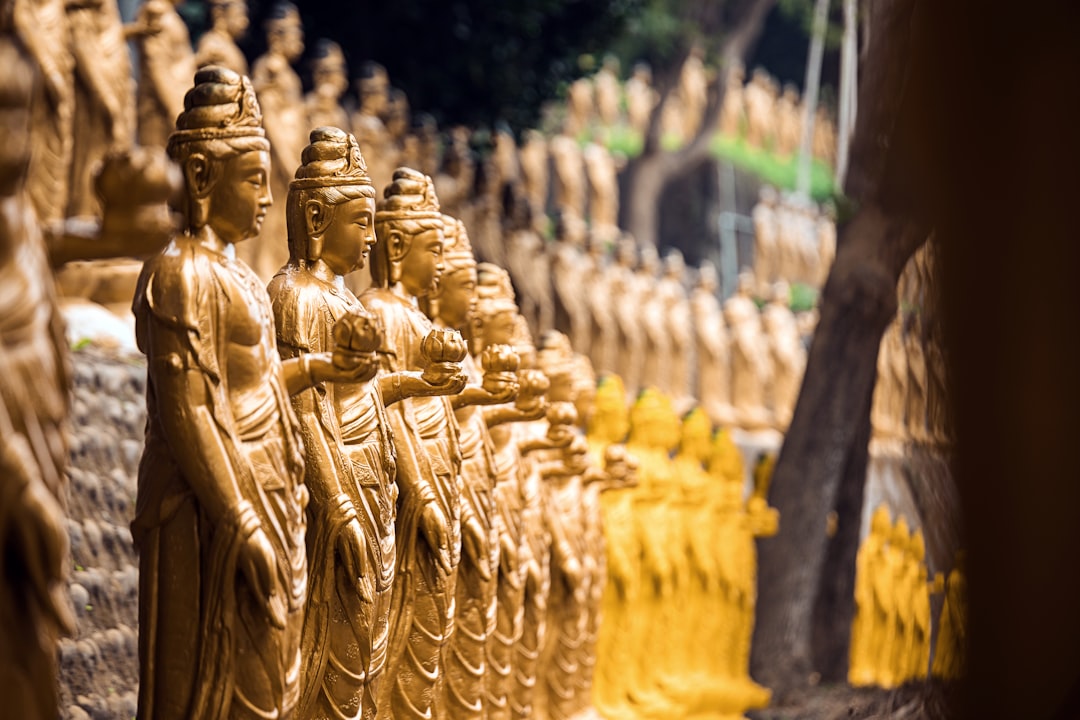 gold buddha statues during daytime