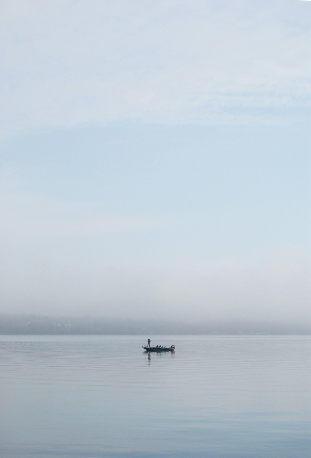 2 people riding on boat on sea during daytime