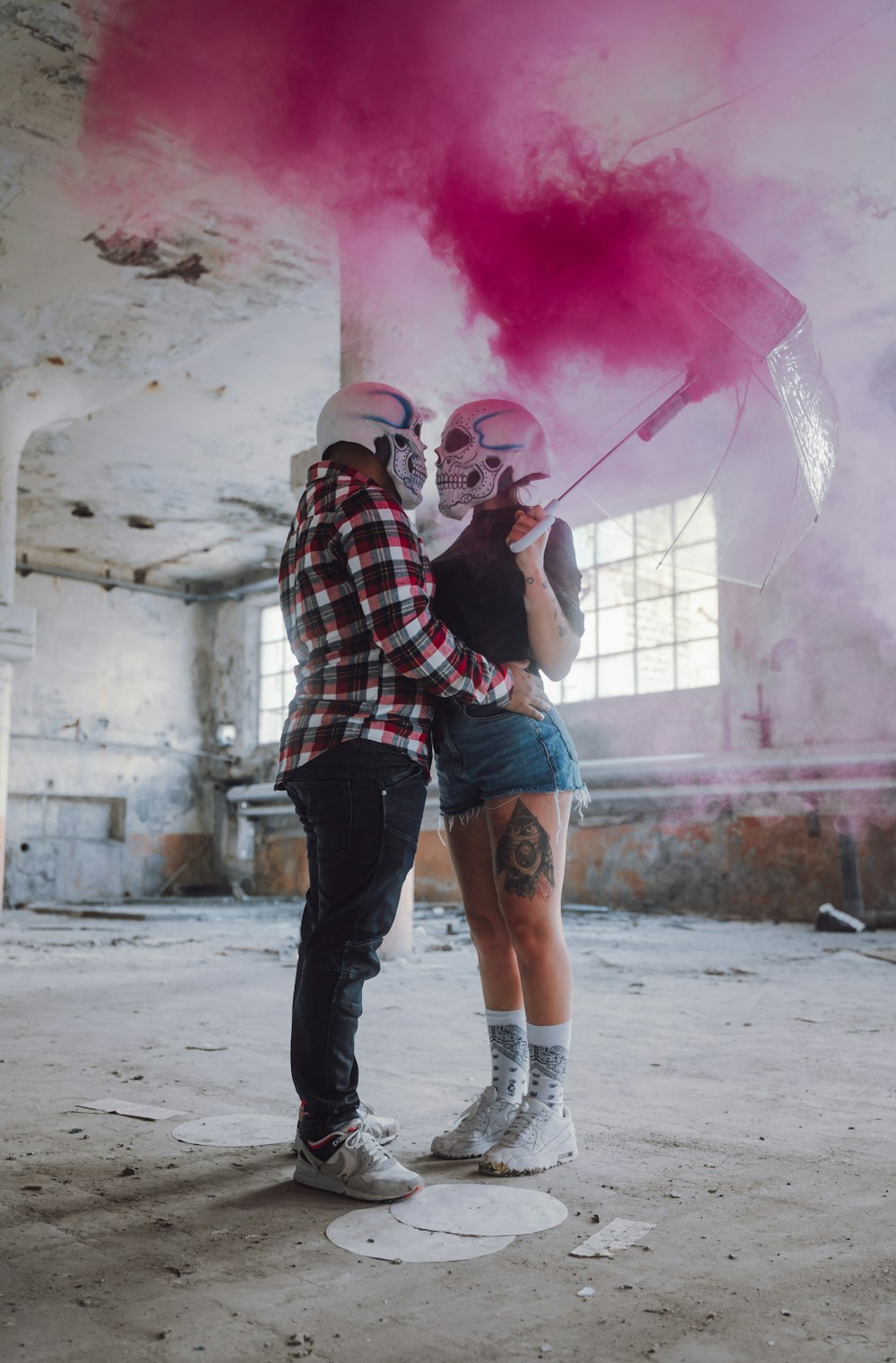 man in red white and black plaid dress shirt holding pink powder