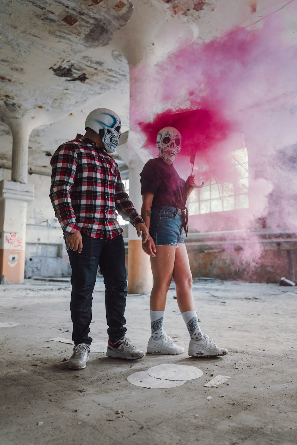 man in red and black plaid dress shirt and black denim jeans standing beside woman in with with with with