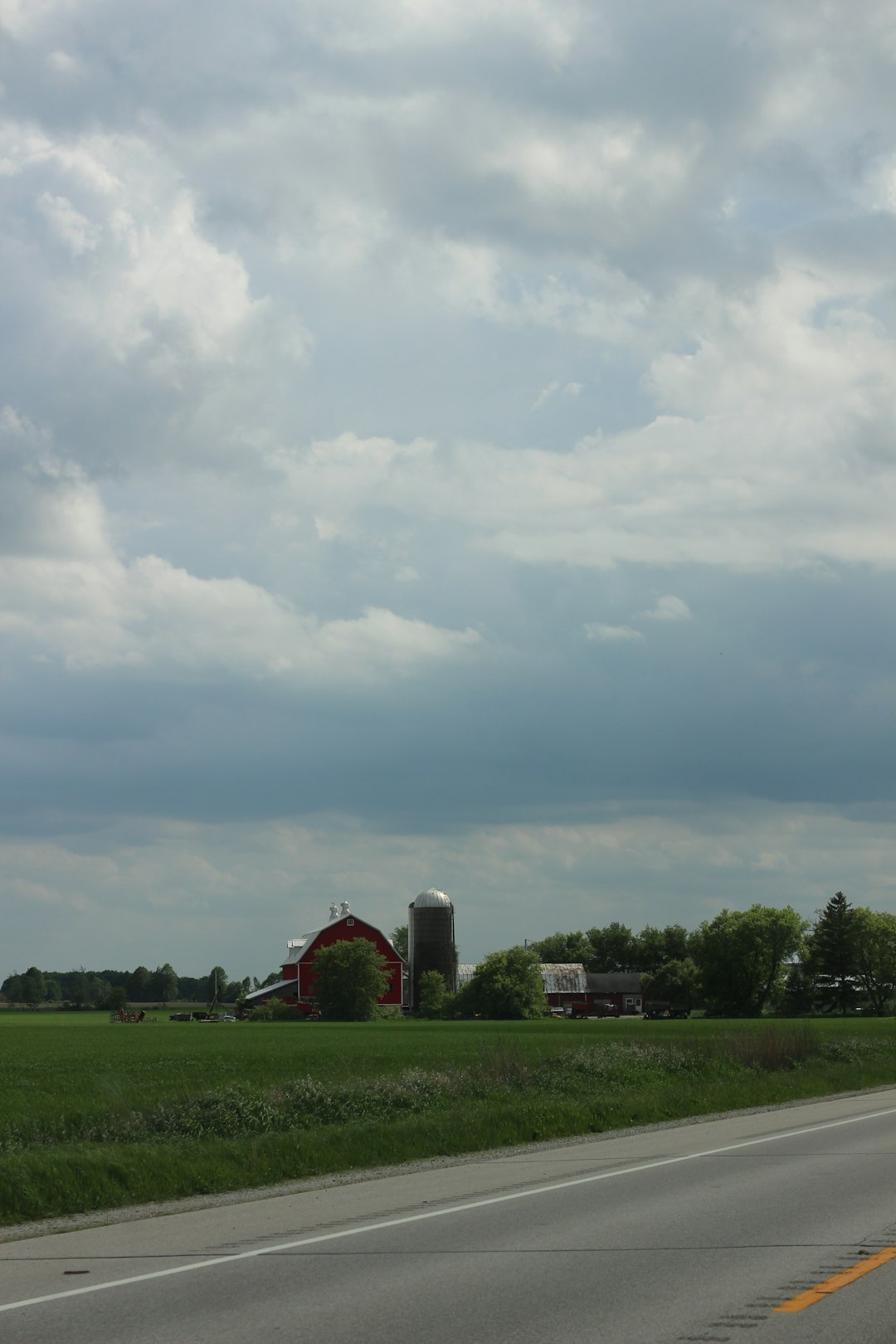 green grass field under cloudy sky during daytime