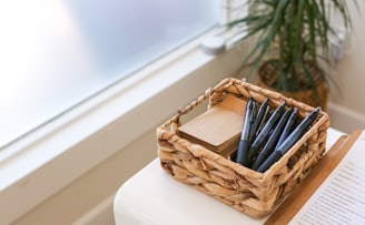 black and white pen in brown woven basket