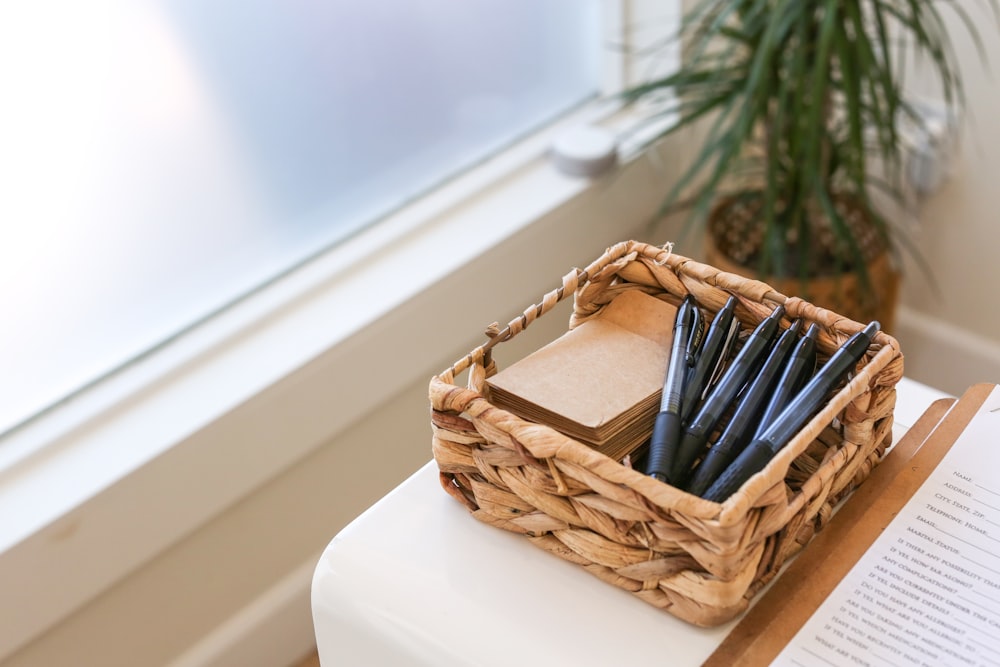 black and white pen in brown woven basket