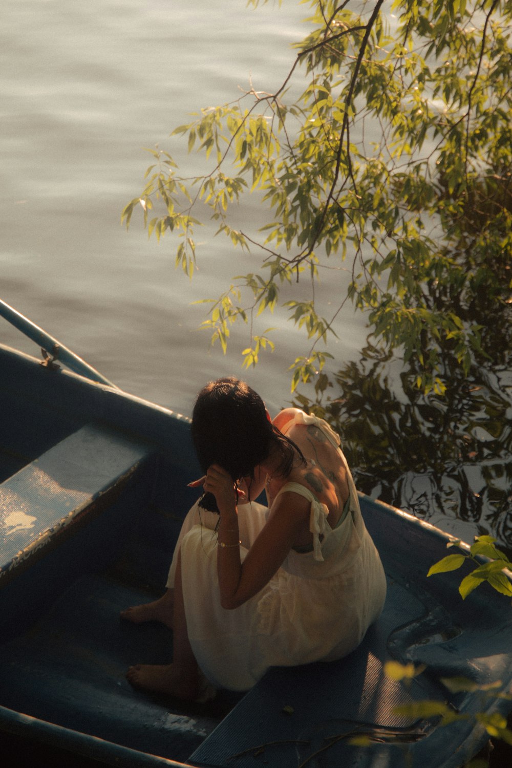 woman in white shirt sitting on boat during daytime