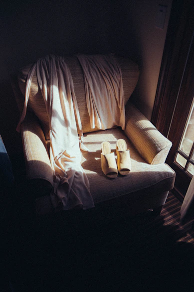 A cozy therapy chair bathed in soft, colorful light inviting relaxation.