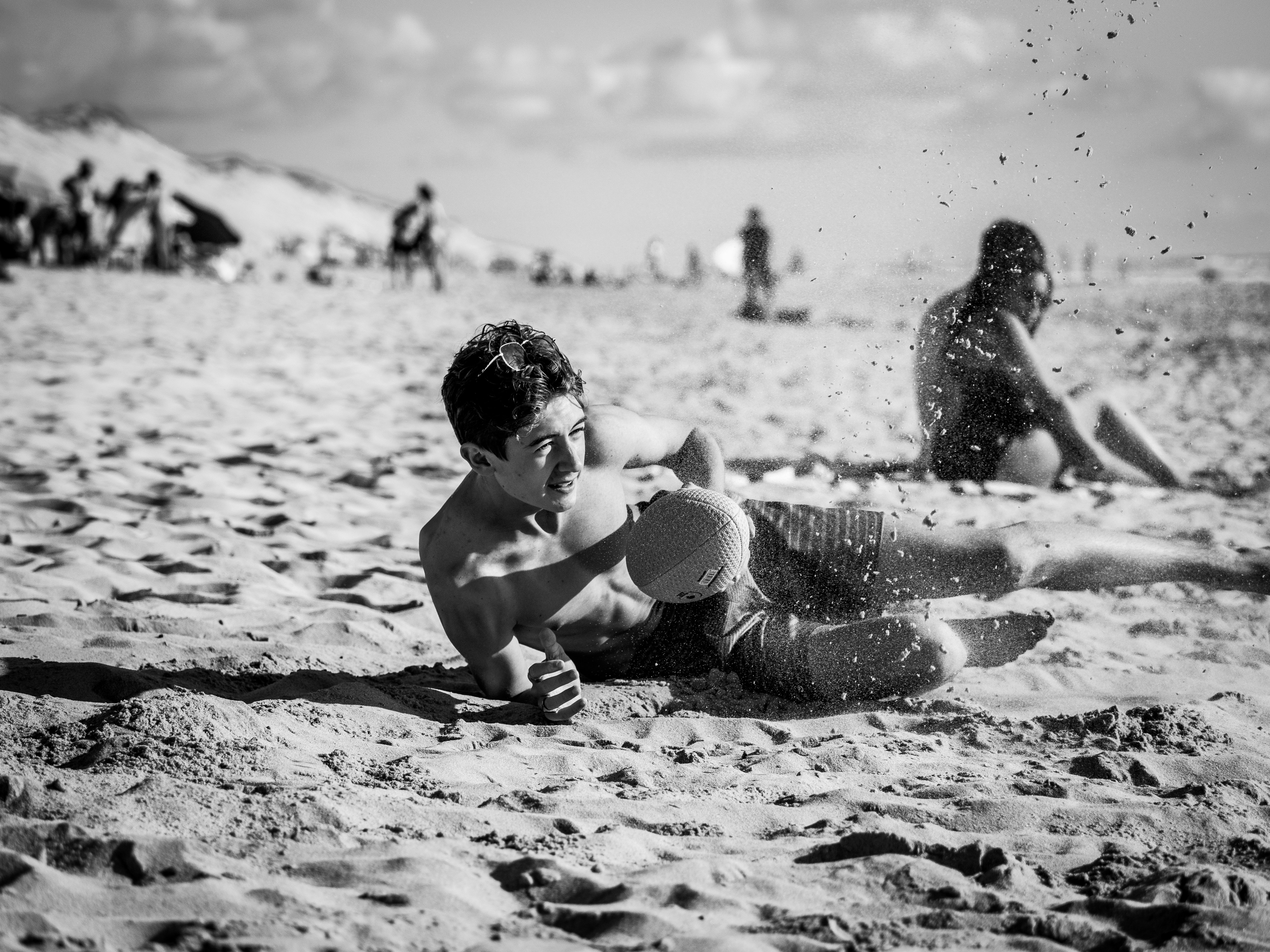 grayscale photo of 2 children playing on beach