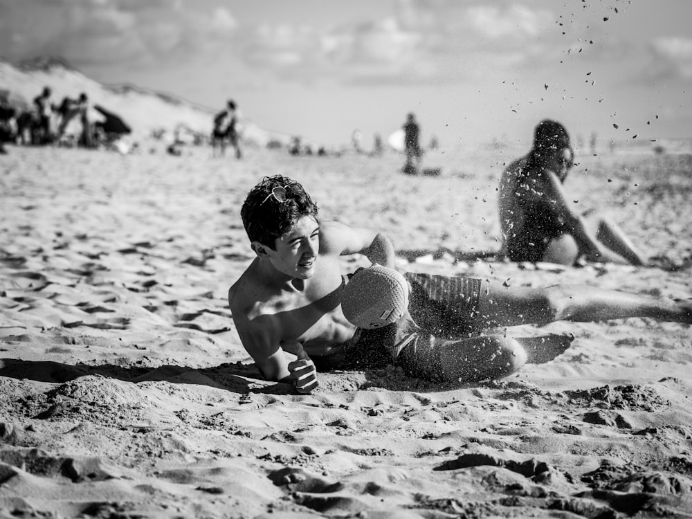 grayscale photo of 2 children playing on beach