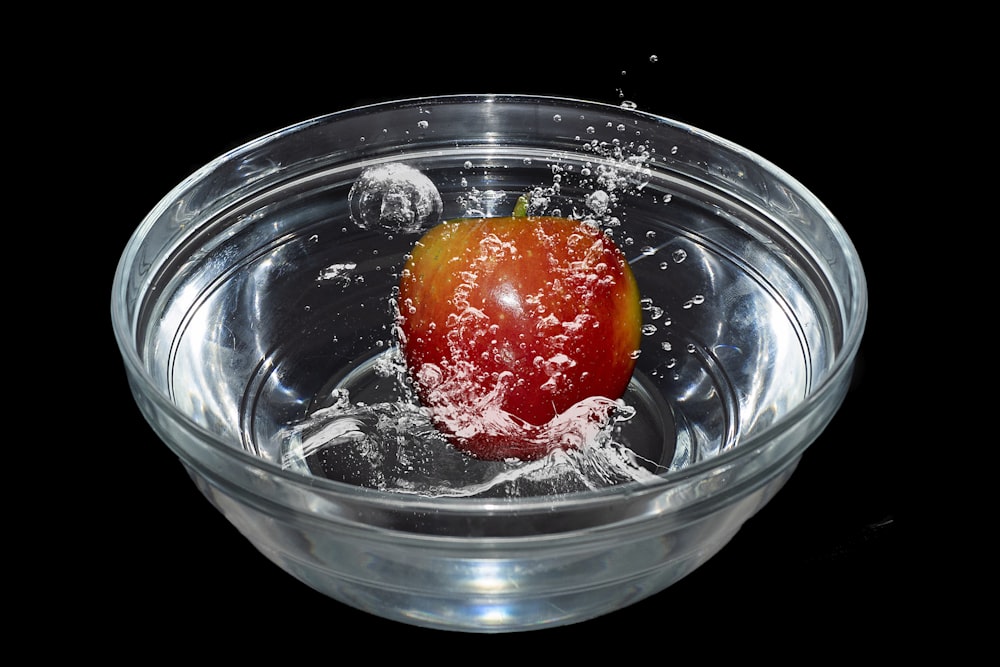 red cherry in clear glass bowl
