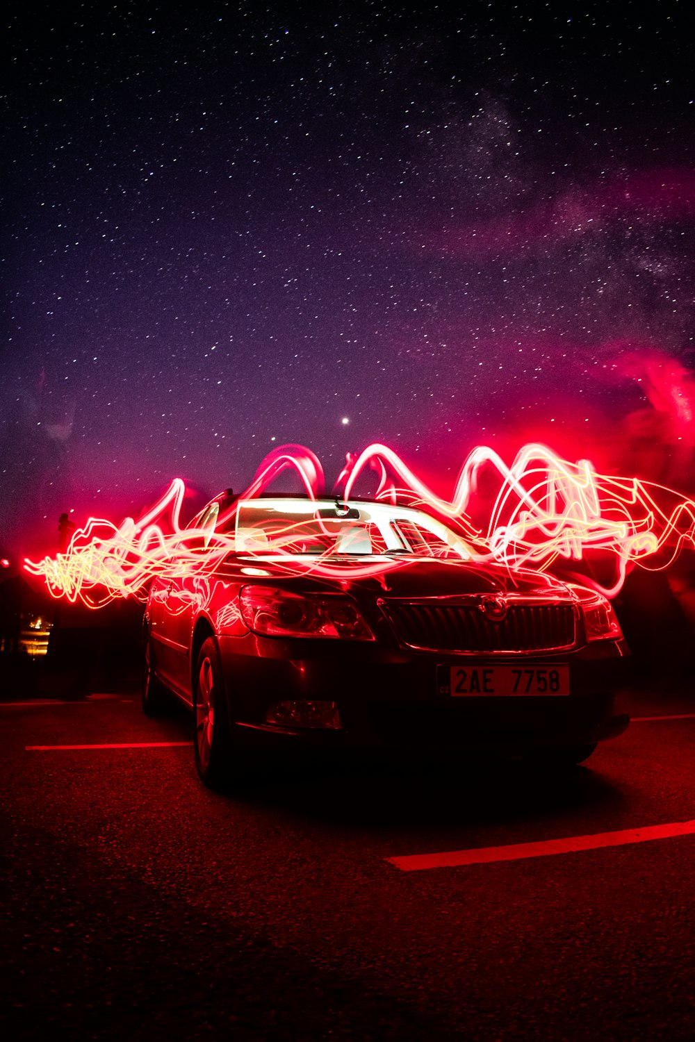 black car with red lights on road during night time