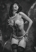 Elegant boudoir scene featuring tasteful lingerie and delicate textures in a warm studio.
