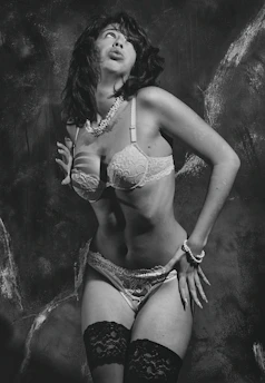 Elegant boudoir scene featuring tasteful lingerie and delicate textures in a warm studio.